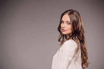 Fototapeta premium beautiful woman looking at camera isolated on grey background