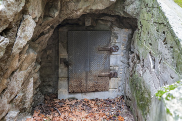 Fototapeta na wymiar Old mine entrance metal door in the Angeles National Forest area of the popular San Gabriel Mountains above LA and Pasadena California. 