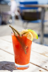 Bloody Mary Cocktail Outside on Wooden Surface