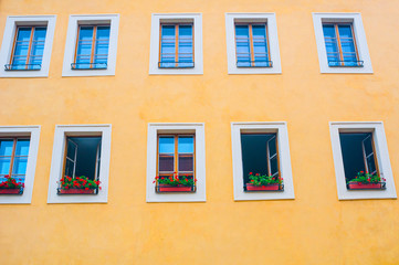 Fototapeta na wymiar Facade of yellow building with windows
