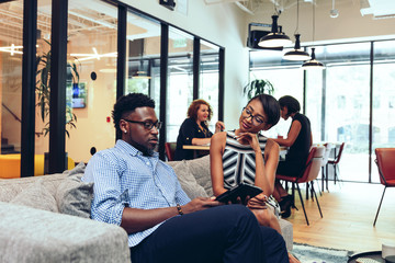 Business people talking with each other in office cafeteria