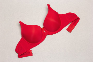 Strapless push up graceful neckline red bra on grey background