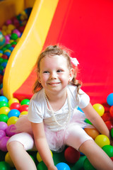 Fototapeta na wymiar Girl playing on the playground, in the children's maze.