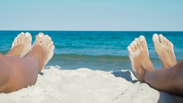 Feet on the background of the sea.
