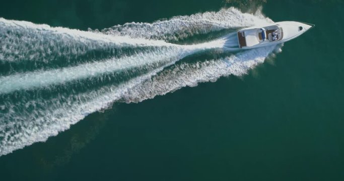 Aerial top down view of recreational speed boat in the atlantic sea, shot in Algarve destination, Portugal.