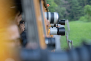 Camera lenses outside bus window