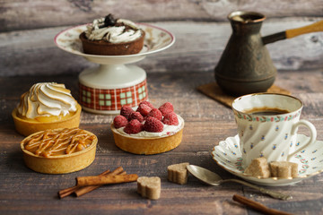 Cup of coffee, coffee pot and cakes