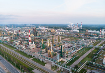 Oil refinery plant industry, Refinery factory, oil storage tank and pipeline steel with sunrise and cloudy sky background, Russia