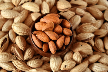 Close-up of peeled and unpeeled almond nuts. Top view