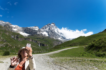 Happy tourist on a mountain landscape at Matterhorn in italian Alps.