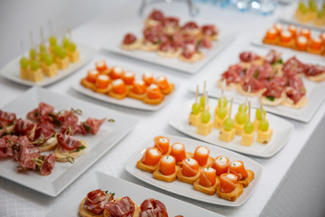 canapes with meat, salmon, sausage.