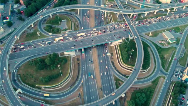 flight of the camera over the traffic junction. Aerial top view of road junction in Moscow from above, automobile traffic and jam of many cars, transportation concept.