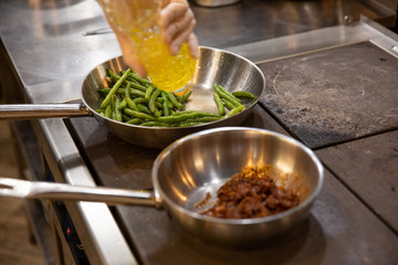 process of cooking meat and asparagus