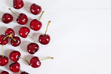 Obraz na płótnie Canvas Cherries on white wooden surface
