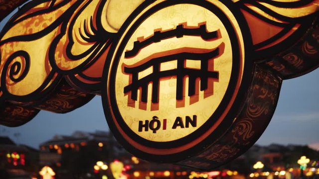 Hoi An, Vietnam - May 10, 2018: Name of the ancient town Hoian written on the light box on the bridge. Inscription of the city destination. 4K Footage filmed at the night time.