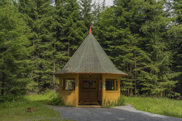 Cottage near spa spring in summer day