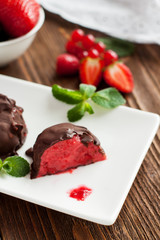 Strawberry ice cream balls in chocolate