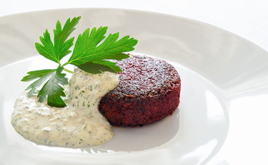 beetroot cutlet with tartar sauce decorated with parsley