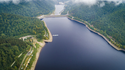 Beautiful natural scenery of river in green forest with mountains, aerial view drone shot