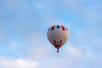 Hot air balloon under blue sky.