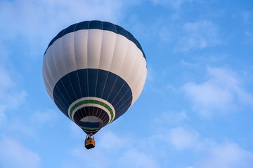 Hot air balloon under blue sky.