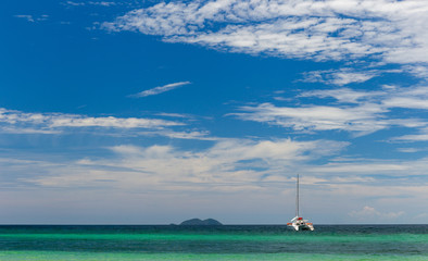 A lonely yacht in a blue green sea