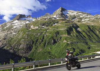 Obraz premium High speed motorcycle passing on Furka Pass road in Switzerland Alps, Europe