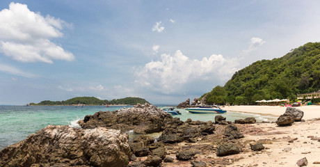 sandy spit. boats in the blue sea.