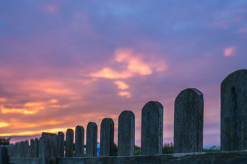 Wooden fence and sunset sky