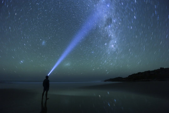 Star gazing man on a starry night.