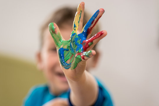 Happy Young Boy Doing Hand Painting