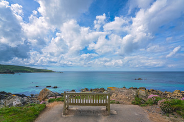 Naklejka na ściany i meble Empty bench on the Cornish coast