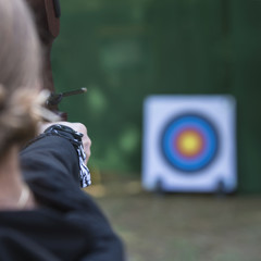 Training exercises for shooting archery on an outdoor target.