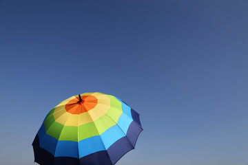 Fototapeta na wymiar Colourful umbrella on a sunny day