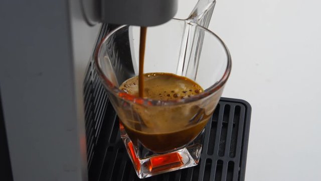 espresso coffee of the highest quality Italian made with a capsule coffee machine falls into a transparent glass coffee cup ,video 4k,
concept of Italy, relax, bio and nature.