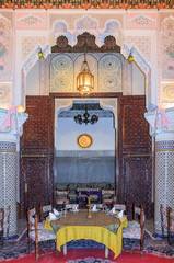 Moroccan restaurant decorated with mosaic and carvings in Fes