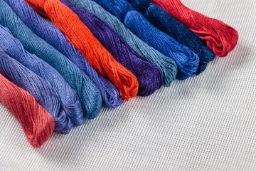 multicolored thread for embroidery on white fabric