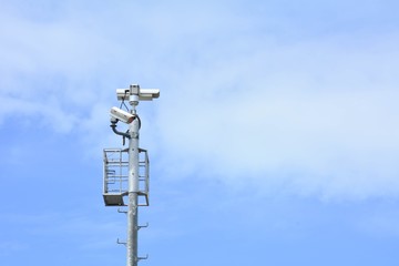 Security CCTV camera isolated on blue sky background