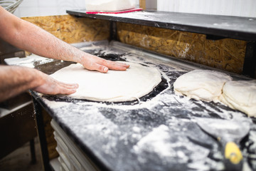 Close up shot of pizza making or preparing process
