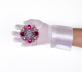 brooch with stones in hand on white isolated background