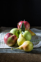 Still life of apples and pears on the table. Autumn mood.