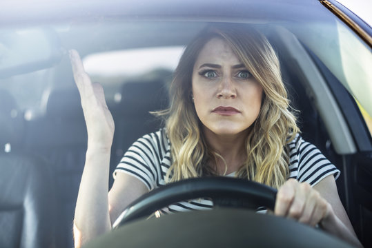 Angry woman driving a car.