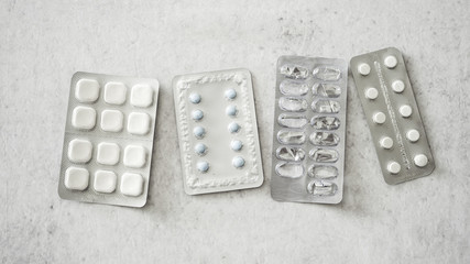 Medicinal tablets on white surface