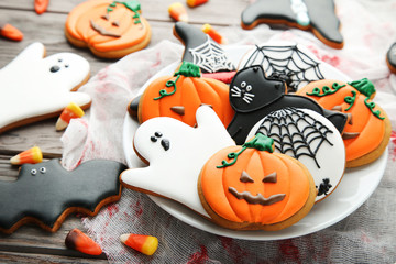 Halloween gingerbread cookies in plate on wooden table - Powered by Adobe