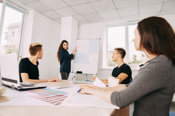 creative team business meeting and goals visualization. designers discussing affairs and work at new project at studio