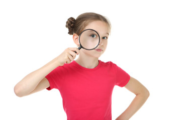 Cute young girl with magnifying glass on white background