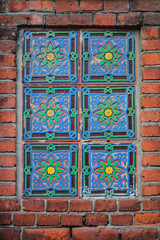 Beautiful flower ornament pattern on the brick wall, a decorative element of the wall.