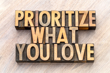 prioritize what you love word abstract in wood type