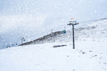 Mountain chairlifts in snow