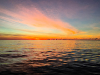 Colorful sky as dawn breaks over calm waters in the Atlantic Ocean